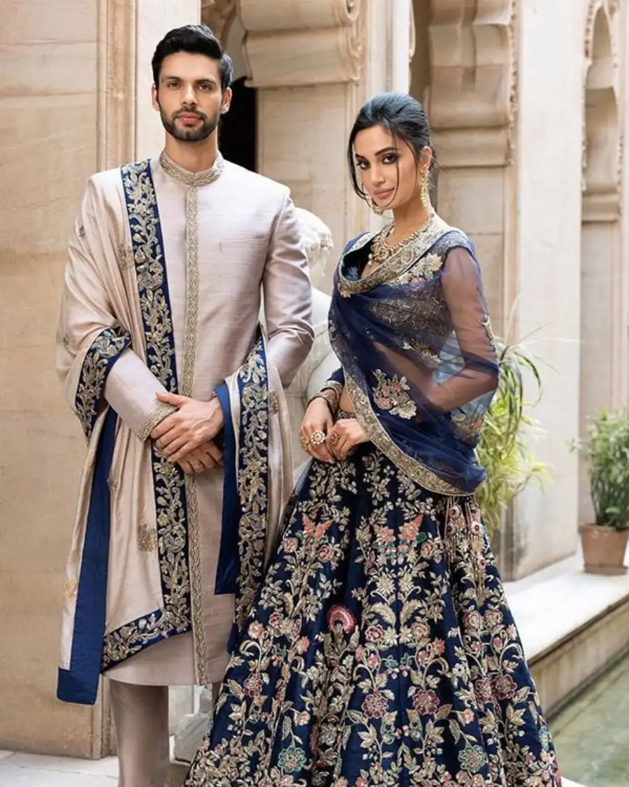Couple in embroidered traditional wedding attire.