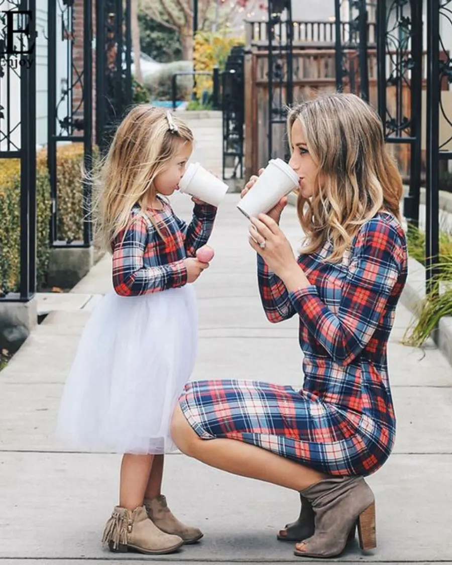 Mom and daughter in matching plaid dresses.