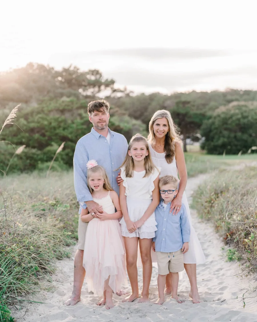 Family dressed for vacation on sandy beach