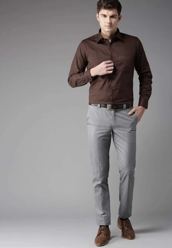 Man wearing brown grey outfit