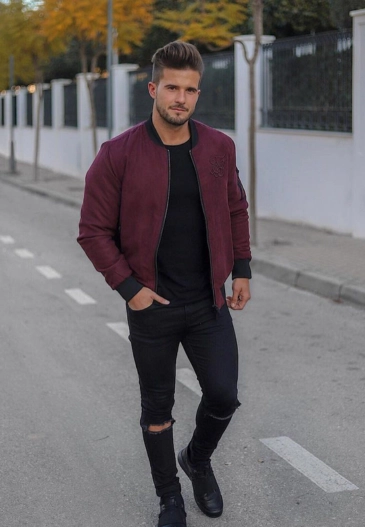 Man in bomber jacket and ripped jeans.