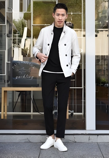 Man in white jacket, black pants, and white sneakers